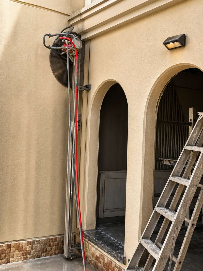 Wall saw track mounted on a building facade